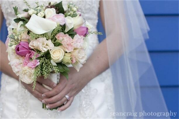 Mid shot of bride holding flowers with two hands