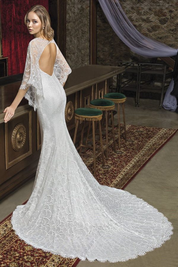 Wedding gown CM7973 - Trumpet silhouette gown with illusion neckline and open back. Made of an allover lace - Back view