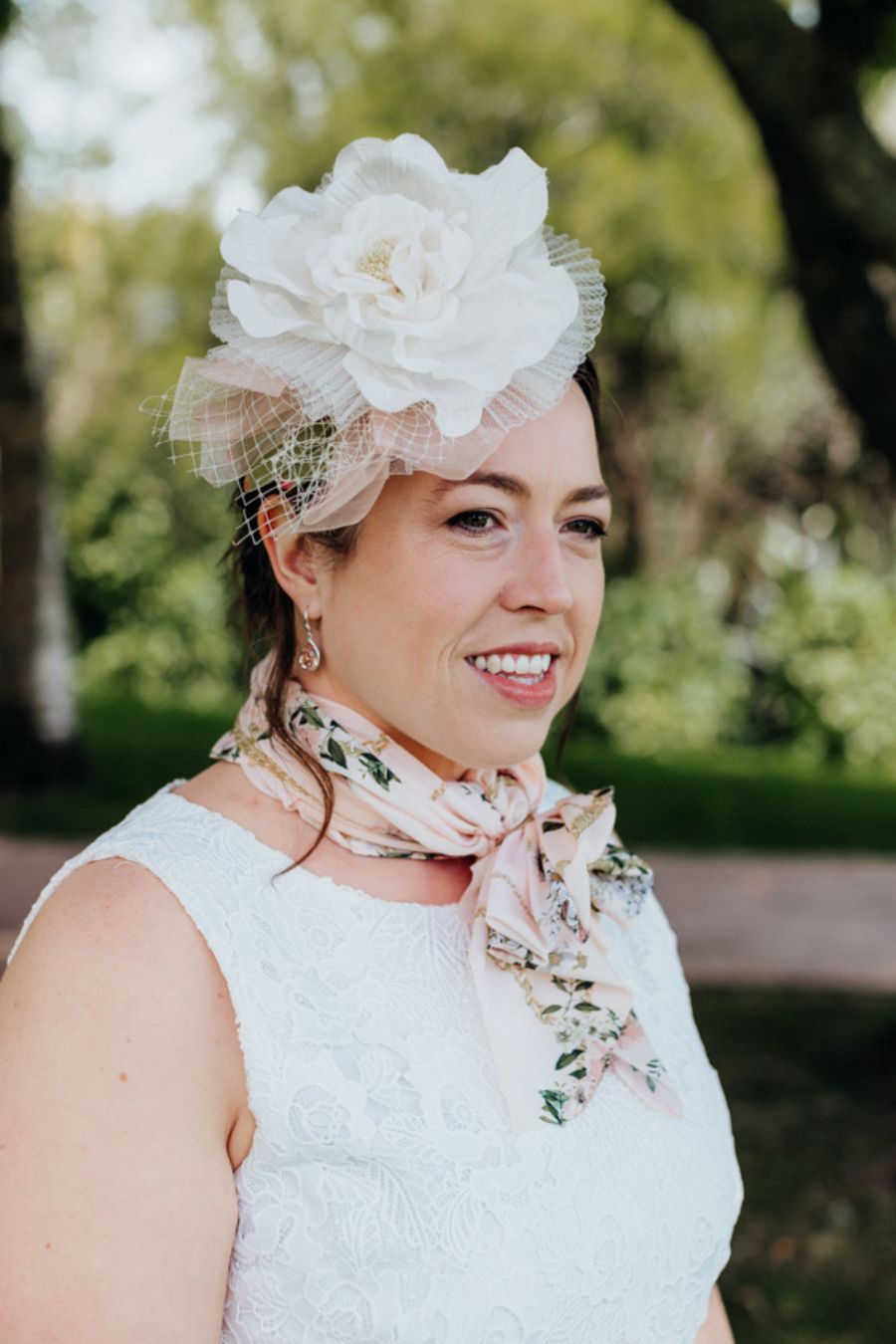 Ivory Lace Dress, close up view with soft pink accessories.