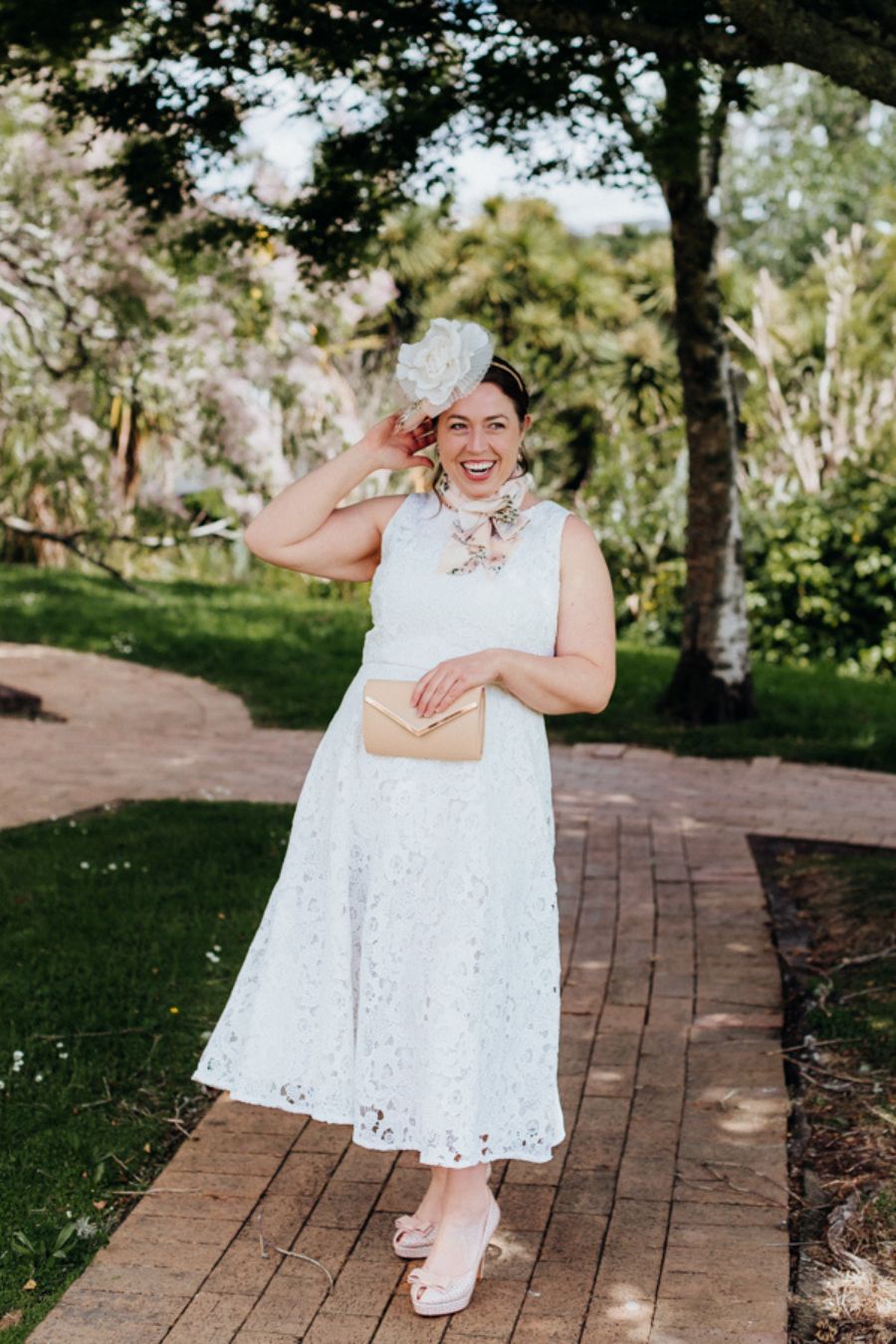 Ivory Lace Dress, front view with soft pink accessories.